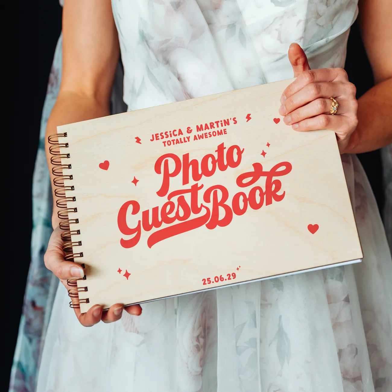 Front cover of retro wedding guest book featuring bold vintage-style red print on natural birch wood with heart and sparkle details