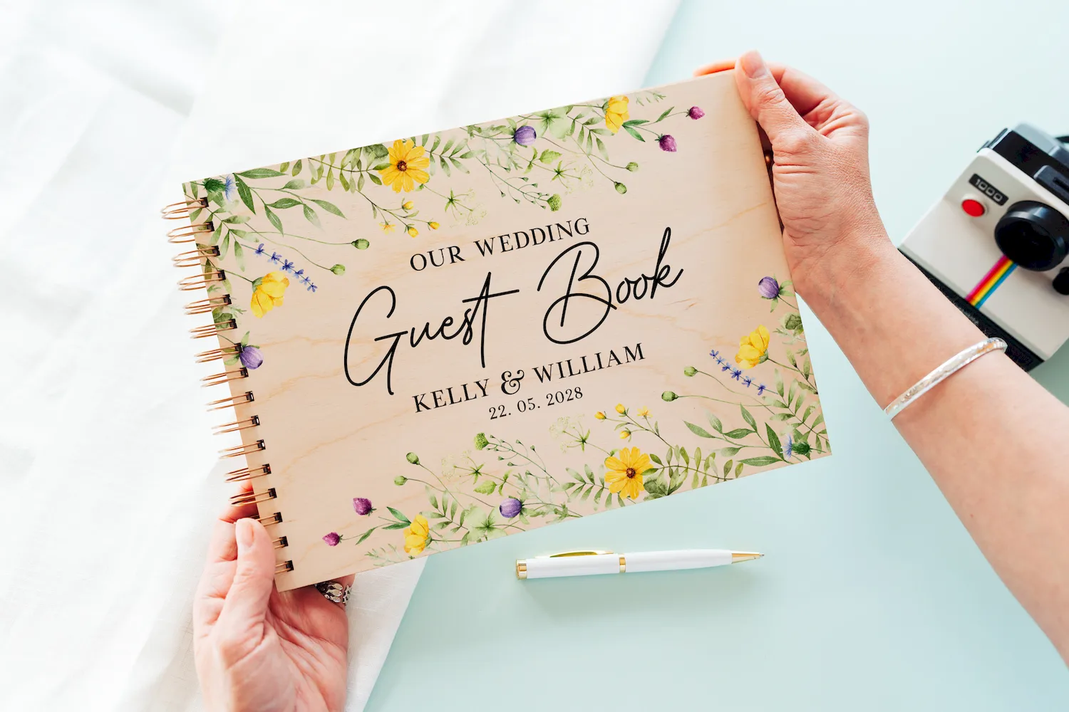 Yellow wildflower wooden wedding guest book landscape view showing full-colour printed cover and spiral binding