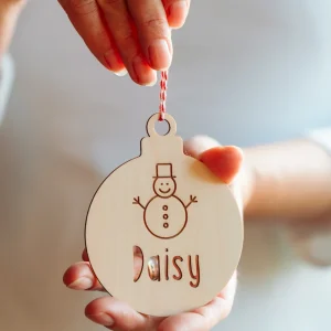 Wooden name Christmas bauble with snowman design and the name Daisy